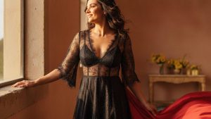 Gabbriette Bechtel photographed post-wedding in a sheer black babydoll dress with distressed hem and dark hosiery