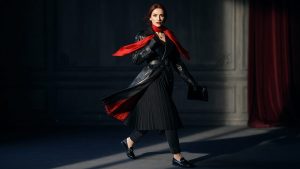 Belted gabardine trench coat worn over a fine-knit crewneck, straight-leg jeans and loafers on a Paris street