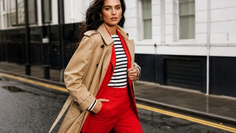 The 7 classic trends every British wardrobe needs (and the one tweak that stops them looking dated) Woman in a camel trench coat, Breton stripe top and tailored wide-leg trousers walking on a London street