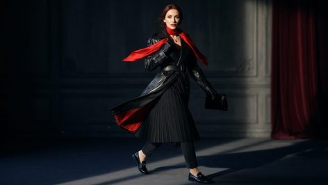 Belted gabardine trench coat worn over a fine-knit crewneck, straight-leg jeans and loafers on a Paris street